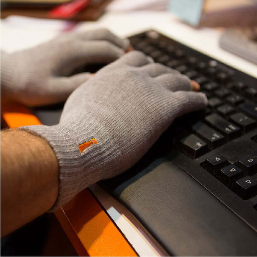 person typing while wearing Incrediwear circulation gloves